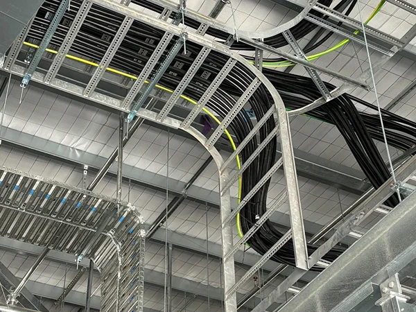 Ladder cable tray supporting cables inside a factory