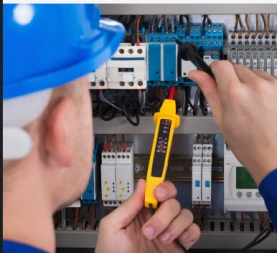 Electricians inspect components of electrical equipment