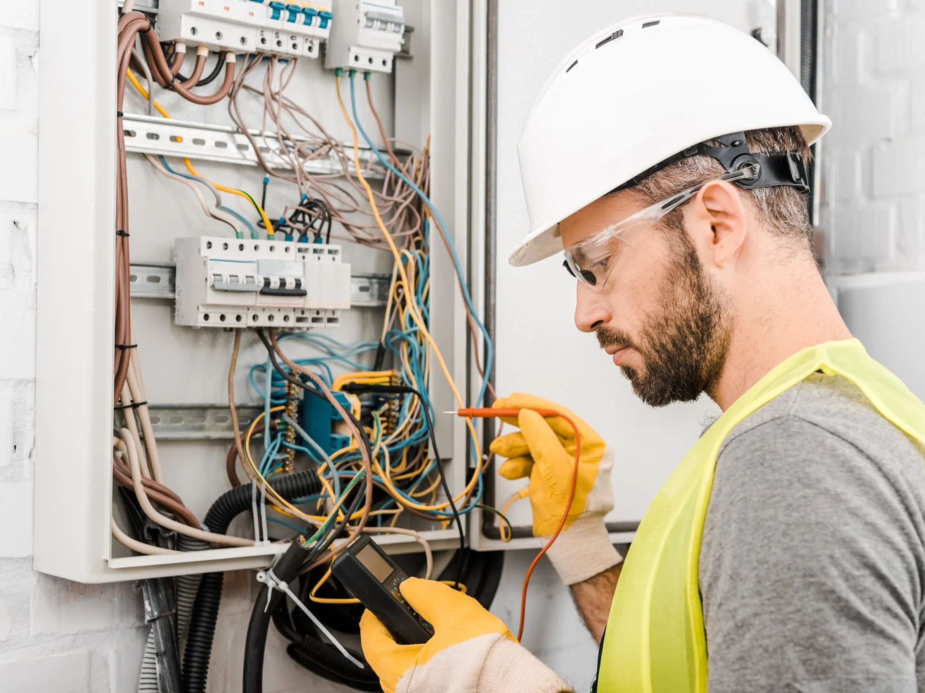 Electrician inspecting an electrical panel