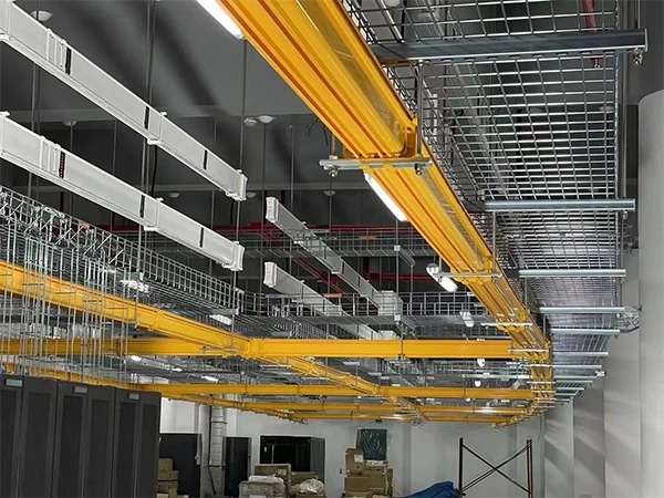 Fiber cable trays and wire mesh cable trays above cabinets